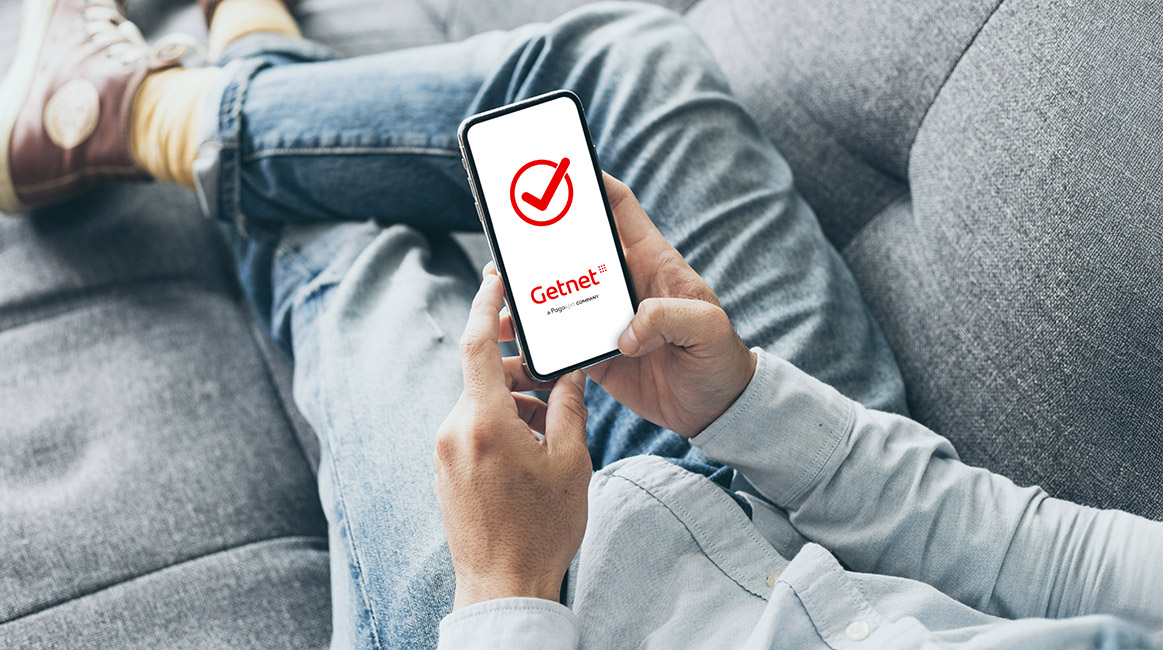 Man hand holding texting using mobile on sofa